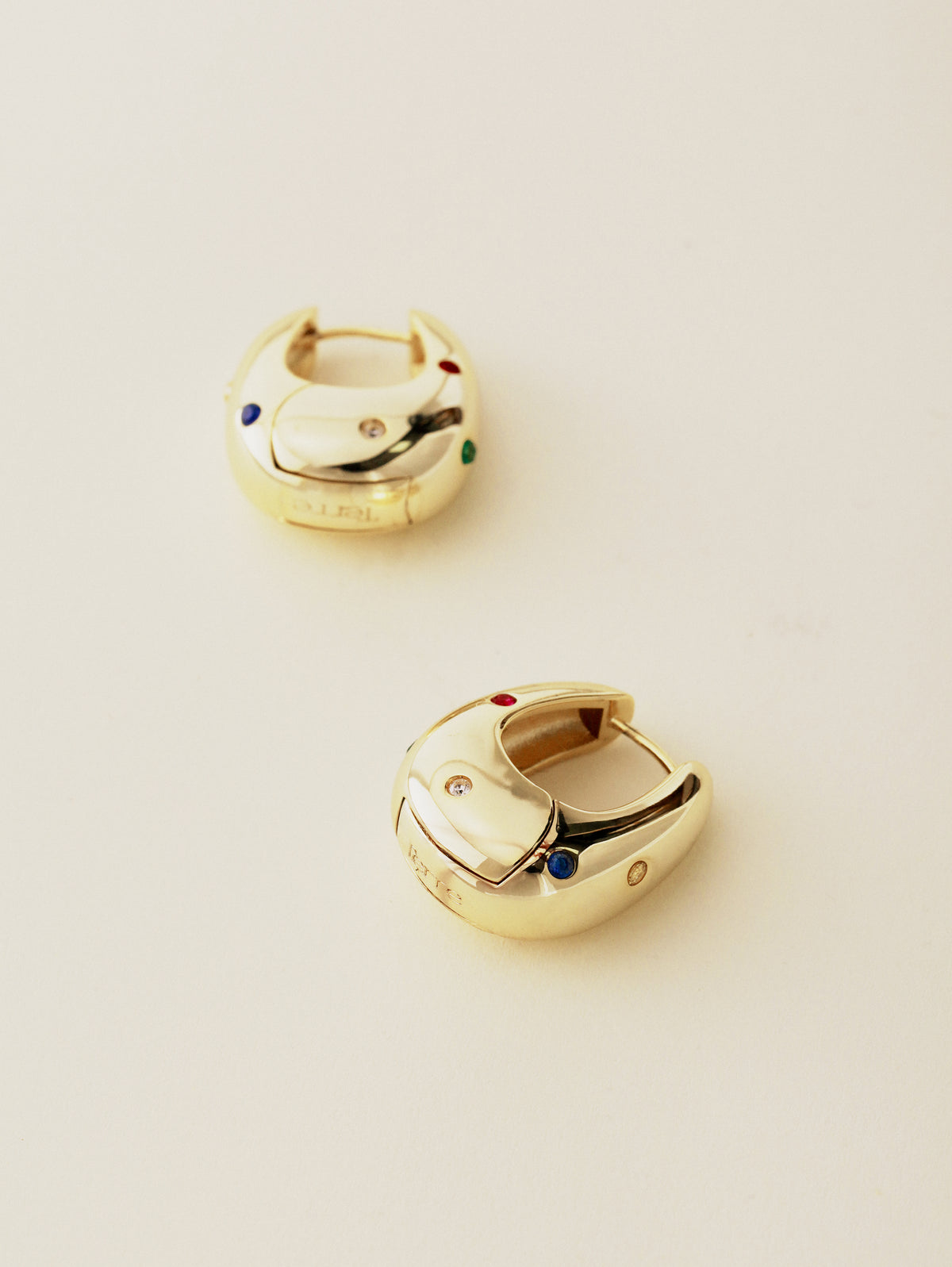 Two Halo Hoops on a cream surface, one turned to show the hinged clasp