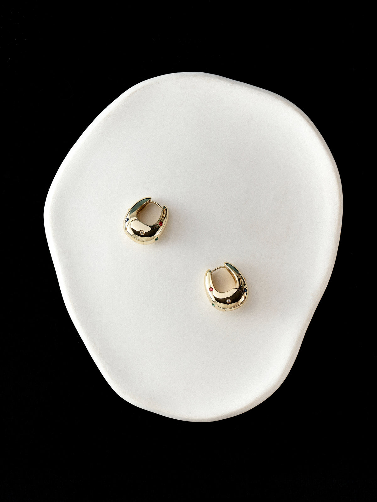 Halo Hoops on a small white ceramic dish against a black background