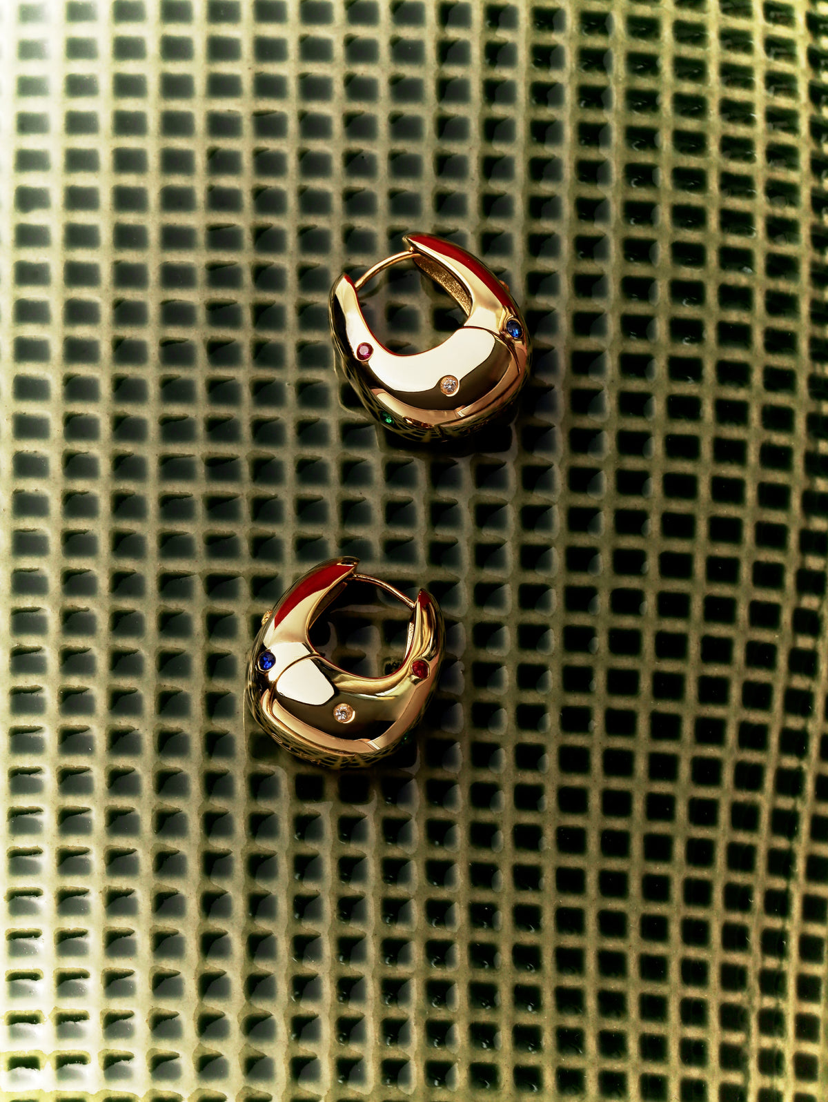 Halo Hoops lying on an olive green woven grid, seen from above